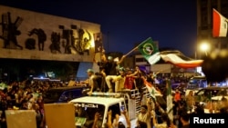 Iraqi supporters of Sadr's movement celebrate preliminary results of parliamentary elections in Baghdad, Iraq, October 11, 2021.