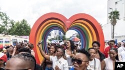 Members of the LGTBQ community take selfies in a Pride march in Johannesburg, South Africa, Oct. 26, 2024. 