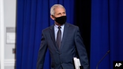 Dr. Anthony Fauci, director of the National Institute of Allergy and Infectious Diseases arrives to participate in a roundtable on donating plasma at the American Red Cross national headquarters on Thursday, July 30, 2020, in Washington. (AP Photo…