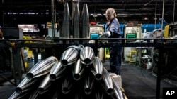 FILE - A steelworker moves an artillery projectile during the manufacturing process at the Scranton Army Ammunition Plant in Scranton, Pennsylvania, on April 13, 2023. The U.S. Defense Department said last week that some weapons deliveries to Ukraine will take months to complete.