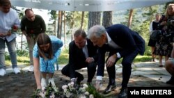 Leader of AUF Party in Norway Astrid Hoem, Swedish Prime Minister Stefan Lofven, and leader of the Norwegian Labor Party Jonas Gahr Store lay flowers at the memorial on Utoeya island to mark the 10th anniversary of the terrorist attack, July 21, 2021.