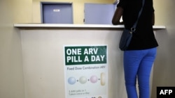 FILE - A woman queues at Phedisong clinic on April 8, 2013, during the launch of the new single dose anti-AIDS drug in Ga-Rankuwa, north of Johannesburg. South Africa is considered a success story for its treatment for and prevention of HIV. 