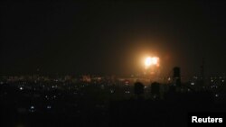 Smoke and flames are seen after an Israeli air strike in the northern Gaza Strip, June 17, 2021. 