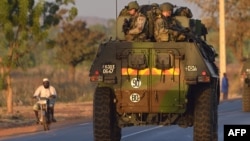French army soldiers stand on armored vehicles as they leave Bamako and start their deployment to the north of Mali as part of the "Serval" operations, January 15, 2013.