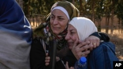 Two women whose relatives were imprisoned embrace outside the infamous Sednaya military prison, just north of Damascus, Syria, Dec. 9, 2024. Thousands of inmates were released after Bashar al-Assad's regime was overthrown Dec. 8.