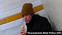 This image release by Pennsylvania State Police shows a video image of Luigi Mangione, a suspect in the fatal shooting of UnitedHealthcare CEO Brian Thompson, at a McDonald's in Altoona, Pennsylvania, Dec. 9, 2024. (Pennsylvania State Police via AP)