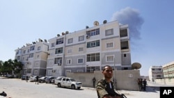 Rebel fighters secure a largely abandoned residential area during fighting in Abu Slim in Tripoli August 25, 2011