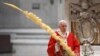 Pope Francis holds a palm branch as he celebrates Palm Sunday Mass behind closed doors in St. Peter's Basilica, at the Vatican, April 5, 2020, during the lockdown aimed at curbing the spread of the COVID-19 infection, caused by the novel coronavirus.