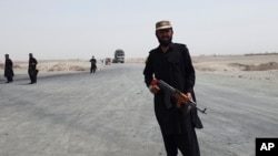 FILE - Pakistani paramilitary soldiers stand guard near a Pakistan-Afghanistan border crossing following fighting between Afghan security forces and the Taliban, in the Spin Boldak border area, in Chaman, Pakistan, July 16, 2021. 