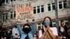  Dawn Cheung and Victoria Do clap and cheer while listening to speakers during a protest against anti-Asian hate crimes at Hing Hay Park in the Chinatown-International District of Seattle, Washington, March 13, 2021. 