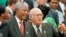 South African President Nelson Mandela, left, and Deputy President F.W. de Klerk chat outside Parliament after the approval of South Africa's new constitution May 8, 1996. (AP Photo, file) 