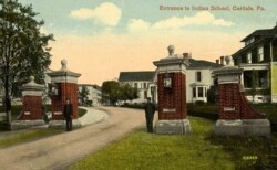 Postcard showing students guarding main entrance, Carlisle Industrial Indian School, Carlisle, Pa., ca. 1905.