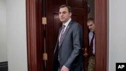 FILE - This March 28, 2017, file photo shows Rep. Justin Amash, R-Mich., followed by Rep. Jim Jordan, R-Ohio, leaving a closed-door strategy session on Capitol Hill in Washington.