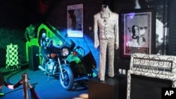 FILE - A Prince costume and motorcycle are on display at Prince's Paisley Park in Chanhassen, Minnesota, Nov. 2, 2016.
