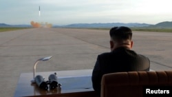 FILE - North Korean leader Kim Jong Un watches the launch of a Hwasong-12 missile in this undated photo released by North Korea's Korean Central News Agency, Sept. 16, 2017.
