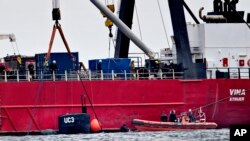 The turret of sunken privately built and owned submarine submarine UC3 Nautilus is seen by the side of a salvage vessel during an operation taking place in connection with a criminal investigation, in Oeresund strait near Copenhagen, Denmark, Saturday, Aug. 12, 2017. Danish prosecutors urged a judge on Saturday to hold in pre-trial detention the owner of an amateur-built submarine, suspected of being responsible for the disappearance of a Swedish woman who had been onboard the ship that later sank.