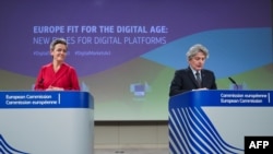 Executive Vice President of the European Commission for A Europe Fit for the Digital Age Margrethe Vestager, left, and European Commissioner for Internal Market Thierry Breton attend an EC press conference in Brussels, Dec. 15, 2020. 