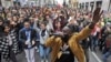 DJ Simon Samaki Osagie, with throngs of protesters behind him, sings during an anti-racism rally, in Milan, Italy, March 2, 2019