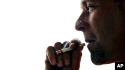 John Cormier smokes a cigarette on Main Street in Westminster, Mass., Thursday, Nov. 6, 2014. 