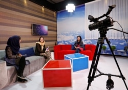 FILE - Afghan presenters record their morning program at the Zan TV station (women's TV) in Kabul, Afghanistan, May 8, 2017.