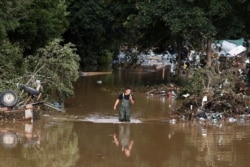 A man walks through floodwater following heavy rain in Bad Neuenahr-Ahrweiler, Germany, July 15, 2021.