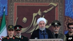 President Hassan Rouhani speaks at a military parade marking 39th anniversary of outset of Iran-Iraq war, in front of the shrine of the late revolutionary founder Ayatollah Khomeini, just outside Tehran, Sept. 22, 2019.