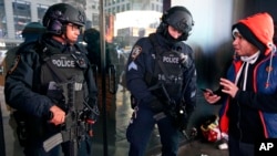 A pedestrian asks directions from two heavily armed counterterrorism officers stationed in Times Square, Thursday, Dec. 29, 2016, in New York. 