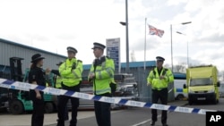 Police officers secure a cordon outside the vehicle recovery business "Ashley Wood Recovery" in Salisbury, England, March 13, 2018. 