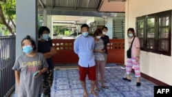 This handout photo from Thailand's San Sai District Administrative Office taken May 9, 2021, and released June 2, 2021, shows five Myanmar nationals, including three Democratic Voice of Burma journalists during their arrest at a residence in Chiang Mai.