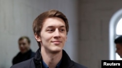 FILE - Student and blogger Yegor Zhukov, under house arrest after being detained at a rally for fair elections, walks inside a court building in Moscow, Sept. 25, 2019.