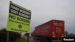 FILE - A sign for "No border" is seen on the border between Northern Ireland and Ireland in Jonesborough, Northern Ireland, Dec. 10, 2018.