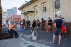 People wait in line to be tested for the coronavirus at Royal Perth Hospital, in Perth, Australia, Jan. 31, 2021.