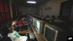 Chinese youths use computers at an internet cafe in Beijing, China, 2006 (FILE).