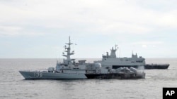 FILE - A Royal Malaysian Navy's missile corvette and an offshore patrol vessel are seen March 13, 2014.