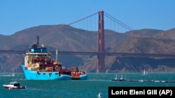 A ship tows The Ocean Cleanup’s first buoyant trash-collecting device toward the Golden Gate Bridge in San Francisco en route to the Pacific Ocean on Saturday, Sept. 8, 2018. (Lorin Eleni Gill/AP)