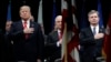FILE - President Donald Trump, Attorney General Jeff Sessions, center and FBI Director Christopher Wray stand during the National Anthem at the FBI National Academy graduation ceremony in Quantico, Va. 