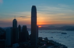 The skyline of the business district is silhouetted at sunset in Hong Kong, July 13, 2020.