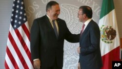 U.S. Secretary of State Mike Pompeo, left, and Mexican Foreign Minister Luis Videgaray smile after a press conference in Mexico City, July 13, 2018.