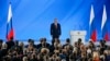 Russian President Vladimir Putin and officials listen to the national anthem after President's address to the Federal Assembly at the Manezh exhibition hall in downtown Moscow on January 15, 2020.