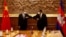 Chinese Foreign Minister Wang Yi, left, greets with Cambodian counterpart Prak Sokhonn in Phnom Penh, Cambodia, Sept. 12, 2021.