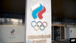FILE - A man exits the Russian Olympic Committee building in Moscow, Russia, Feb. 28, 2018.