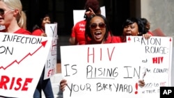 FILE - Community advocates protest the defunding of two local community HIV clinics, in Baton Rouge, La., April 13, 2017.