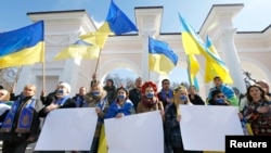 Women with their mouths taped over and others participants attend a pro-Ukraine rally in Simferopol, March 13, 2014.