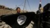 A member of Iraqi Counter Terrorism Service holds an Islamic State militant flag as he celebrates in the Old City of Mosul, Iraq July 9, 2017. 