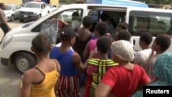 A still image taken from a video shows women, who were freed by police with other girls and women that were held captive, entering a bus in Lagos, Nigeria, Sept. 30, 2019. 