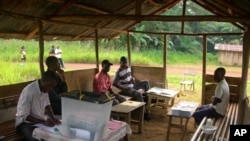 Members of the election commission of the polling station of Atout near Medouneu, Gabon, wait for electors during the legislative elections on December 17, 2011.