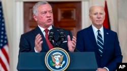 Jordan's King Abdullah II, accompanied by President Joe Biden, right, speaks in the Cross Hall of the White House in Washington, Monday, Feb. 12, 2024.