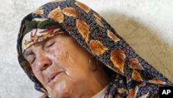 A woman mourns for her grandson Oussama Achour, a rebel fighter killed during a battle with forces loyal to Moammar Gadhafi at Misrata's western front line, May 31, 2011