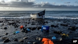 FILE - A wooden boat used by migrants from Morocco is seen at the coast of the Canary Islands, Oct. 16, 2020.