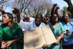 FILE - Zimbabwean medical staff march in Harare, Sept. 19, 2019. Zimbabwean doctors protesting the alleged abduction of a union leader won a high court ruling allowing them to march and handover a petition to the parliament.